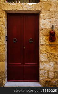 Outdoor relief of Virgin Saint Mary, Madonna with Child, near the door. Entrance to a old house on the island of Malta