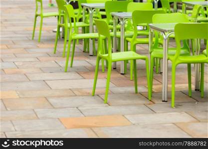 Outdoor restaurant coffee open air cafe green chairs with table. Summer vacation on resort