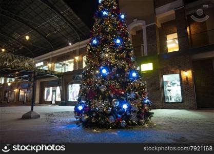 Outdoor shot of christmas tree in lights on street at night