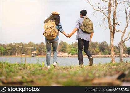 Outdoor shot of happy young loving couple hikers at valley of the mountain having fun on summer vacation.. Outdoor shot of happy young loving couple hikers at valley of th