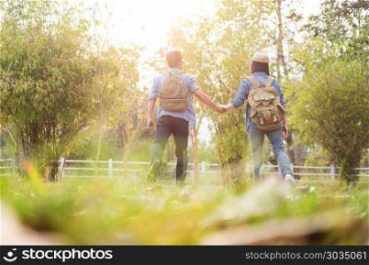 Outdoor shot of happy young loving couple hikers at valley of the mountain having fun on summer vacation.. Outdoor shot of happy young loving couple hikers at valley of th