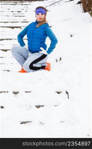 Outdoor sport exercises, sporty outfit ideas. Woman wearing warm sportswear getting ready before exercising outside during winter.. Woman wearing sportswear exercising outside during winter