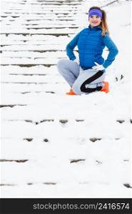 Outdoor sport exercises, sporty outfit ideas. Woman wearing warm sportswear getting ready before exercising outside during winter.. Woman wearing sportswear exercising outside during winter