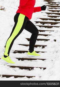 Outdoor sport exercises, sporty outfit ideas. Woman wearing warm sportswear running jogging outside during winter.. Woman wearing sportswear exercising during winter