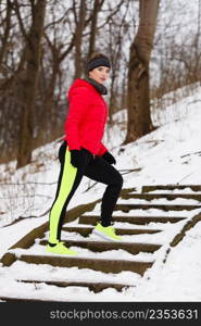 Outdoor sport exercises, sporty outfit ideas. Woman wearing warm sportswear running jogging outside during winter.. Woman wearing sportswear exercising during winter