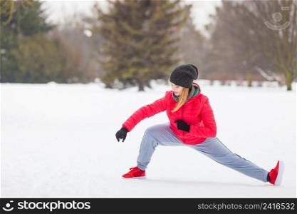 Outdoor sport exercising, sporty outfit ideas. Woman wearing warm sportswear training karate outside during winter.. Woman wearing sportswear training boxing outside