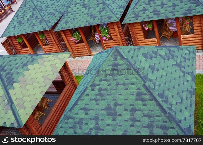 Outdoor summer cafe in wooden small houses. View from the top