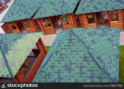 Outdoor summer cafe in wooden small houses. View from the top