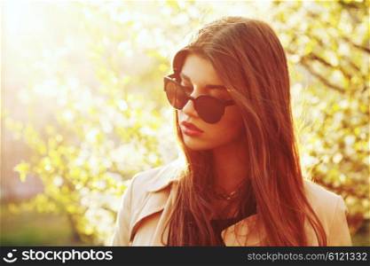 Outdoor summer portrait of young beautiful pretty girl posing in sunset lovely light