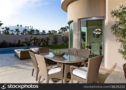 Outdoor table on patio by swimming pool