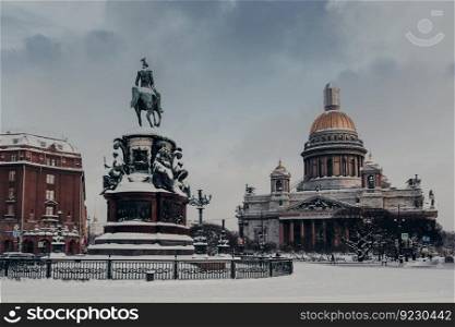 Outdoor view of St Isaac s Cathedral and Monument to Nicholas I in Saint Petersburg, Russia, covered with snow. Famous landmarks of city. Sightseeing and traveling concept