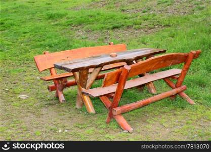 outdoor wooden bench near a lodge in the mountains