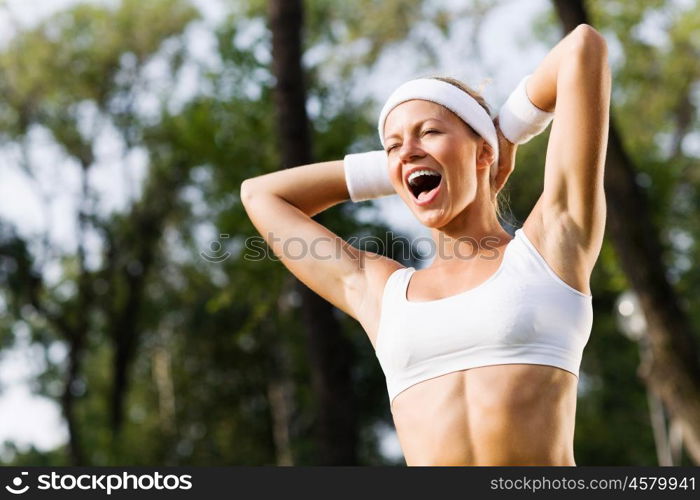 Outdoor workout. Young attractive sport girl in white sport wear in park