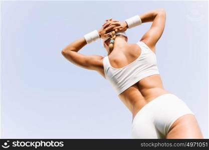 Outdoor workout. Young attractive sport girl in white sport wear in park