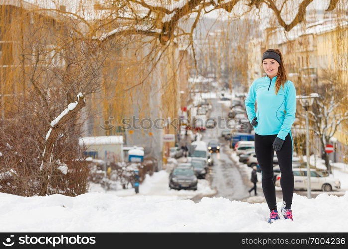 Outdoors activities people spare time concept. Young woman outside during winter. Attractive girl has blue jumper and leggins.. Young woman outside during winter.