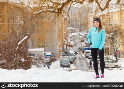 Outdoors activities people spare time concept. Young woman outside during winter. Attractive girl has blue jumper and leggins.. Young woman outside during winter.