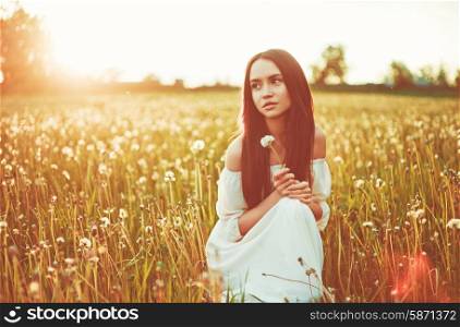 Outdoors art photo of beautiful lady in dandelions field