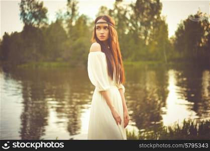 Outdoors fashion photo of beautiful bohemian lady at river