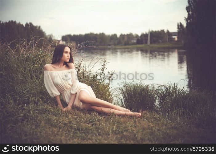 Outdoors fashion photo of beautiful romantic lady at river