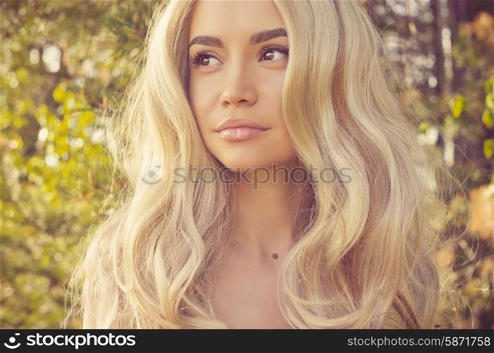 Outdoors portrait of beautiful romantic lady with magnificent healthy hair