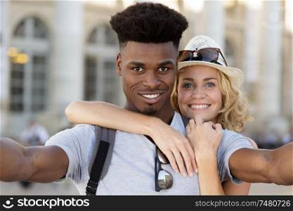 outdoors selfie portrait of young cheerful couple