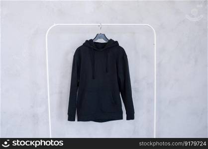 Outerwear, order in the closet, black hoodie, old things, men&rsquo;s sweater, black hoodie, Unisex clothing, large size, children&rsquo;s clothing. A set of mock-ups of a white hoodie ,pocket, hanging on a hanger, holding in his hands, a sweatshirt with pleats.