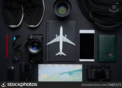 Outfit ,accessories and equipment of traveler on black background with copy space . Travel concept .