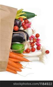 Outgoing fresh vegetables of a paper bag of groceries on white background