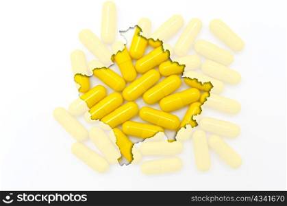 Outlined kosovo map with transparent background of capsules symbolizing pharmacy and medicine