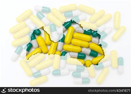 Outlined latvia map with transparent background of capsules symbolizing pharmacy and medicine