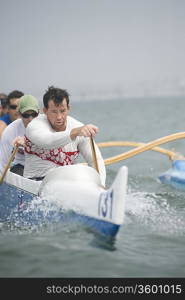 Outrigger canoeing team on water