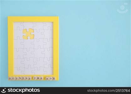 outside box puzzle yellow frame with white jig jaw pieces blue background