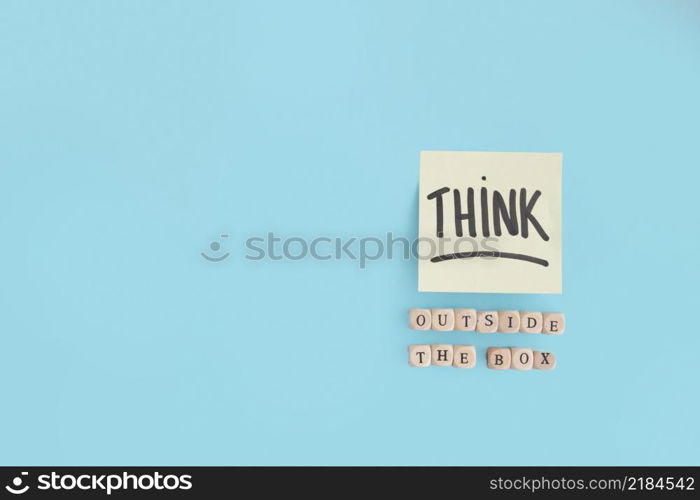 outside box text made with wooden blocks think text adhesive note