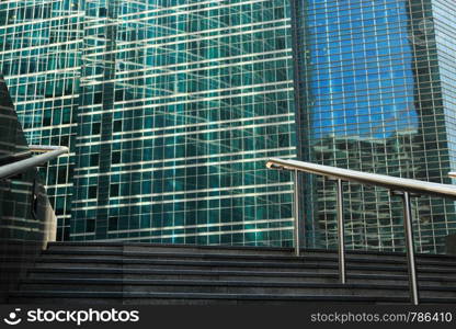 Outside stairs leading to the glass and steel office buildings.