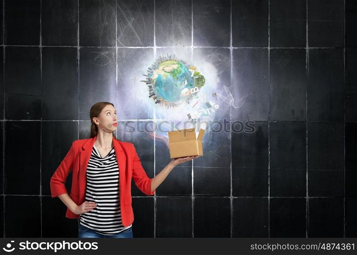 Outside the box thinking. Happy young woman in red jacket opening gift box. Elements of this image are furnished by NASA