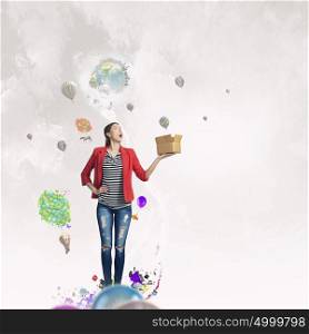 Outside the box thinking. Young woman in red jacket holding carton box in hand. Elements of this image are furnished by NASA