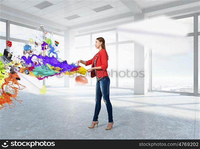 Outside the box thinking. Young woman in red jacket holding yellow bucket in hands
