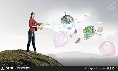 Outside the box thinking. Young woman in red jacket holding yellow bucket in hands. Elements of this image are furnished by NASA
