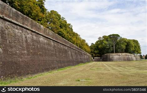 Outside view of the solid ancient fortress walls of Lucca, an Italian town in Tuscany.