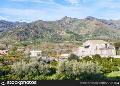 Outskirts of town Gaggi in green hills in spring day, Sicily, Italy