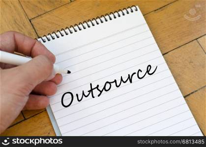 Outsource text concept write on notebook
