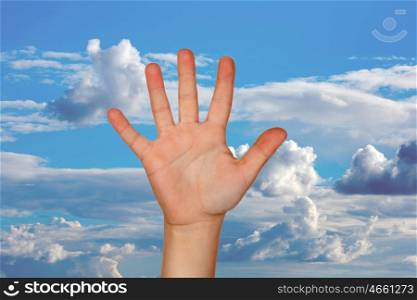Outstretched hand with a nice blue sky with clouds of background