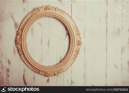 Oval vintage frame on a wooden background. Oval vintage frame