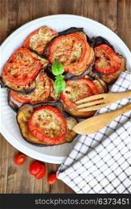 Oven baked eggplant with tomatoes and cheese as tasty vegetarian meal, Thanksgiving homemade food