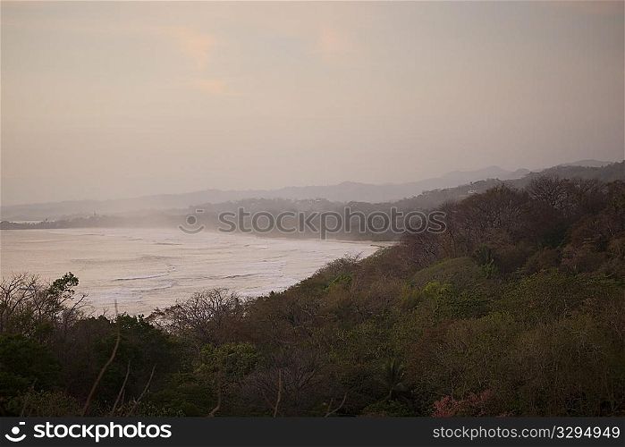 overcast evening landscape of the ocean from the jungle hilltop