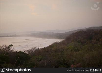 overcast evening landscape of the ocean from the jungle hilltop