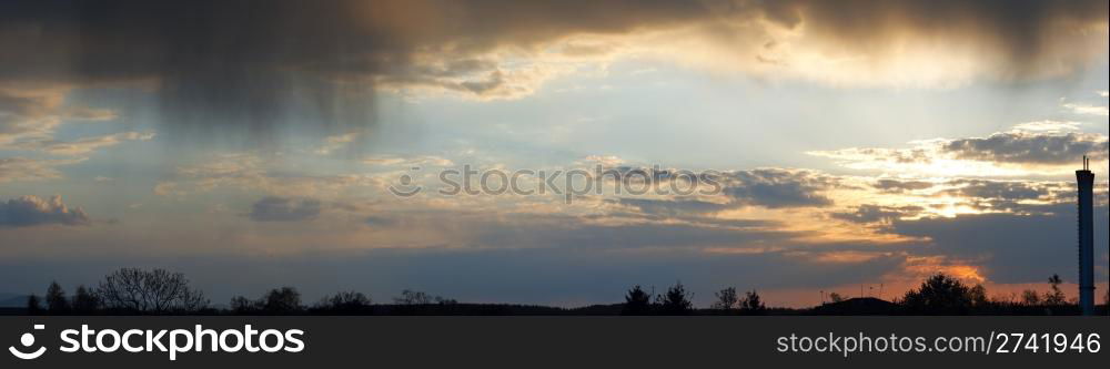 Overcast evening sky with rain clouds panorama view. Seven shots composite picture.