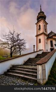 Overcast foggy autumn morning and the small famous Maria Gern pilgrimage church (built in the current form 1708 - 1710), Berchtesgaden, Bavaria, Germany
