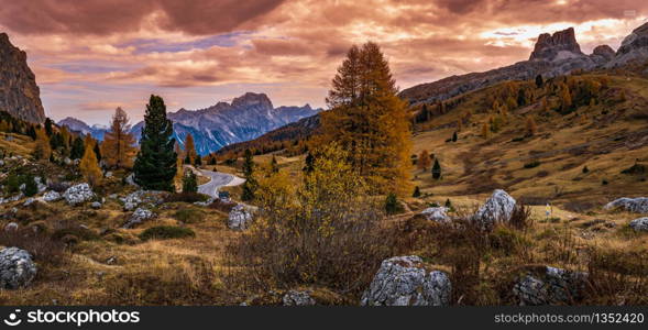 Overcast morning autumn alpine Dolomites mountain scene. Peaceful view near Valparola and Falzarego Path, Belluno, Italy. Picturesque traveling, seasonal, nature and countryside beauty concept scene.