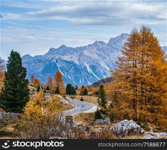 Overcast morning autumn alpine Dolomites mountain scene. Peaceful view near Valparola and Falzarego Path, Belluno, Italy. Picturesque traveling, seasonal, nature and countryside beauty concept scene.